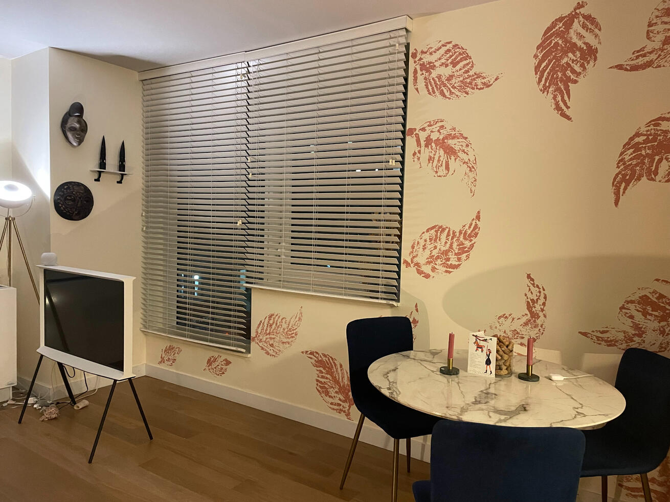 Nook (AFTER) in an Egg Shell White walls, with a custom creative leaf stencil, painted in a Rosemary pink swirl design on the accent wall...